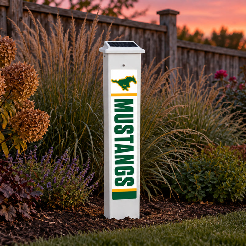 Hempstead Mustangs Solar Glow Post lit up at dusk.