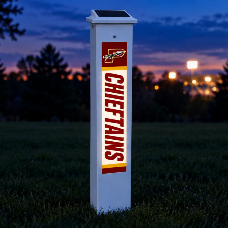 Potosi Chieftains Solar Glow Post lit up at dusk.