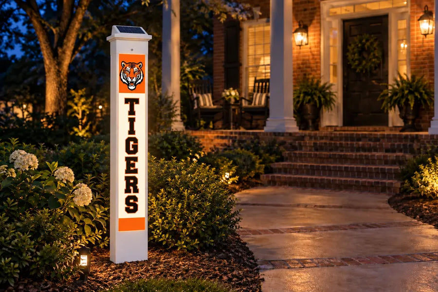 A FanPillar Solar Glow Post glowing beside a front porch at night
